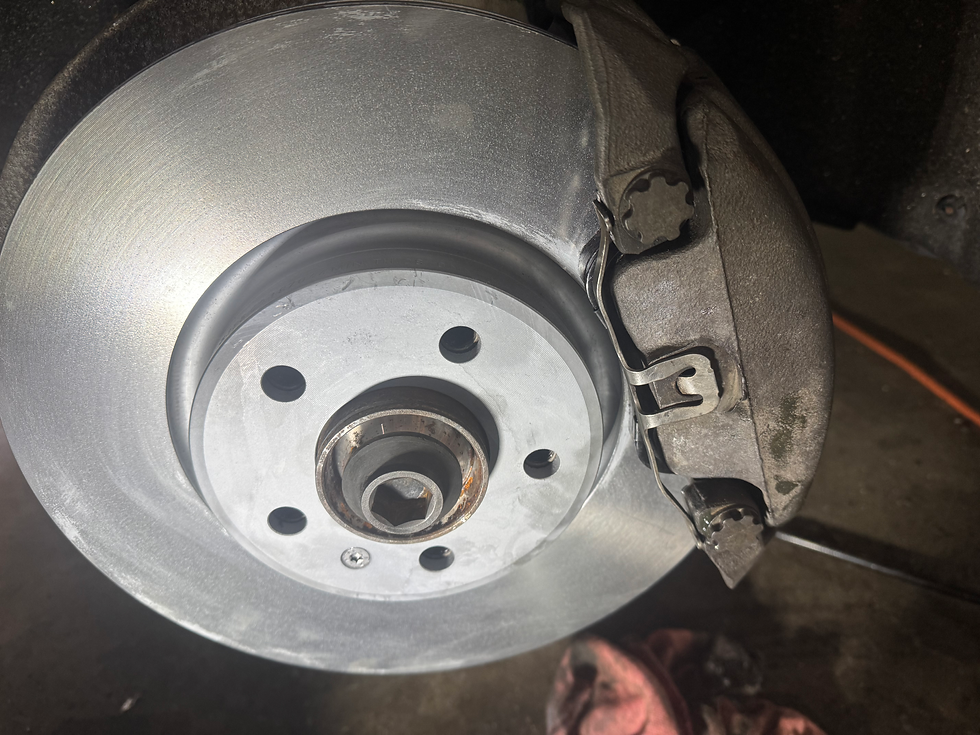 The front brake on the driver’s side. Basically the same except for being larger, having exposed pins to slide the caliper on and using a different spring cliip to retain the pads.