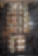 Old electrical fuse panel with multiple round fuses and visible wires, mounted on a dark background. Some corrosion is visible.