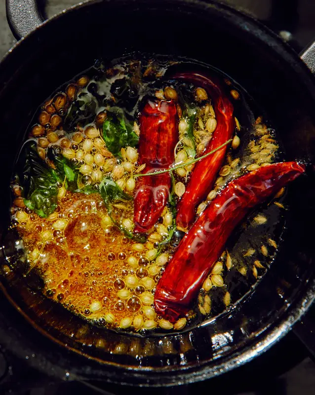 Coriander seeds & red chile in a frying pan