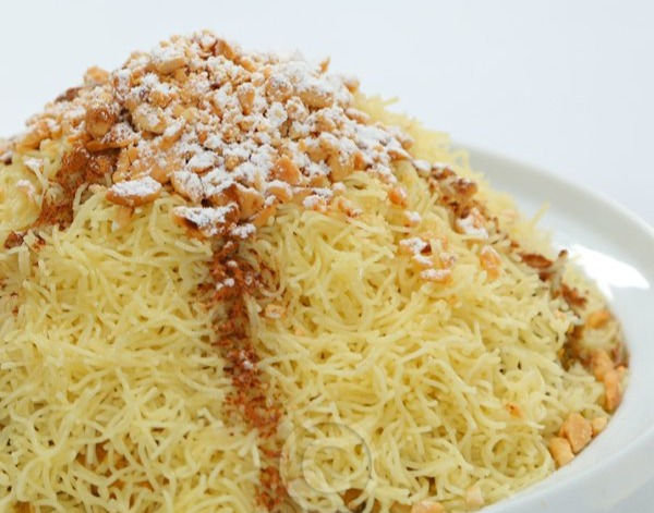A plate of Moroccan Seffa with flavorful toppings