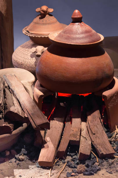 A clay pot on a fire