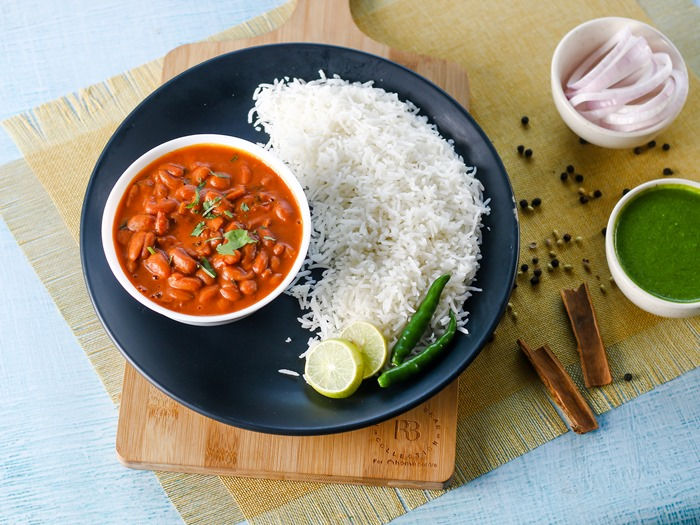 A plate of rajma chawal, a traditional Indian dish of kidney beans cooked in a spiced tomato sauce, served with basmati rice.