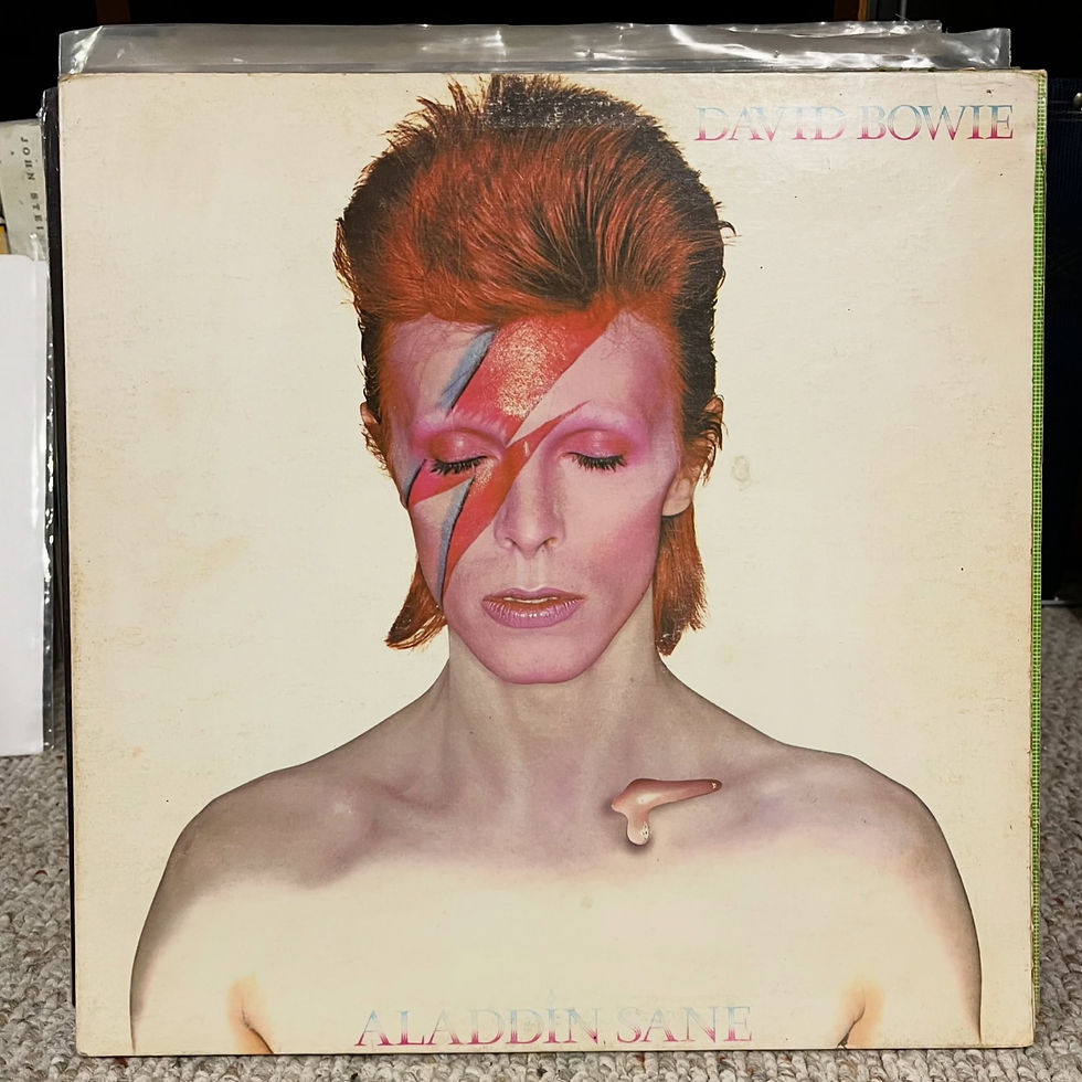 David Bowie album cover with Ziggy-era portrait, lightning bolt face paint, and Aladdin Sane text on a cream background.