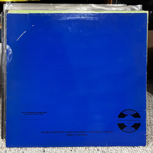 Blue Dead Kennedys album cover reading A Skateboard Party, with live track list and punk slogans in black type.