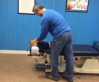 Dr. Kory Adjusts his son, Sawyer