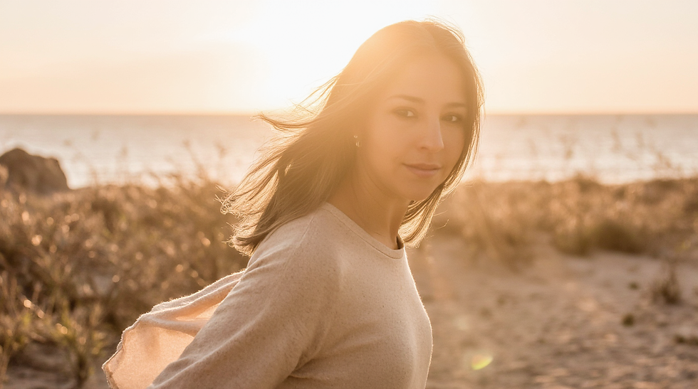 a_photo-realistic_portrait_of_a_woman_stepping_forward_into_warm_golden-hour_light_but_the