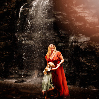 Mom and daughter standing in creek near waterfall at Hobuck Flats, near Buffalo NY during a family photo session with Kimberly A. Muth Photography
