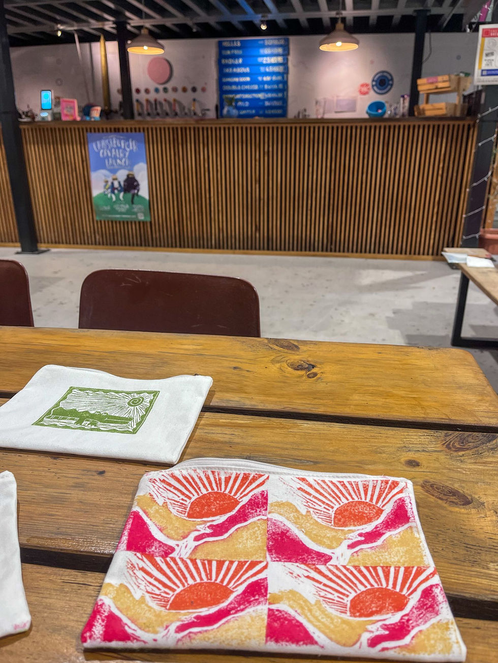 Print of a sunset on a washbag at Left Handed Giant, in Bristol.