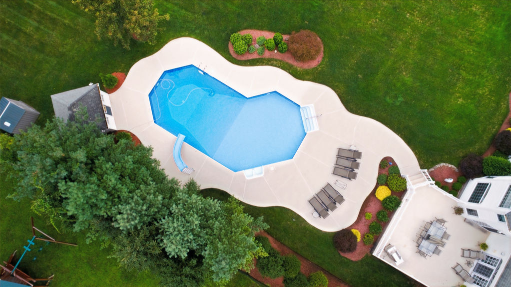 Aerial view of an organic-shaped fiberglass pool designed to complement the surrounding landscape.