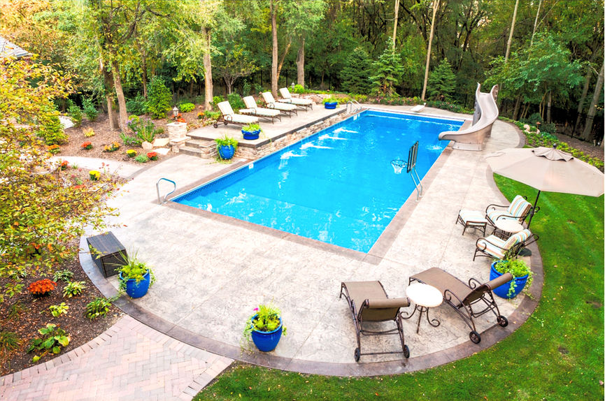 Overhead view of a custom fiberglass pool highlighting layout, decking, and surrounding landscape design.