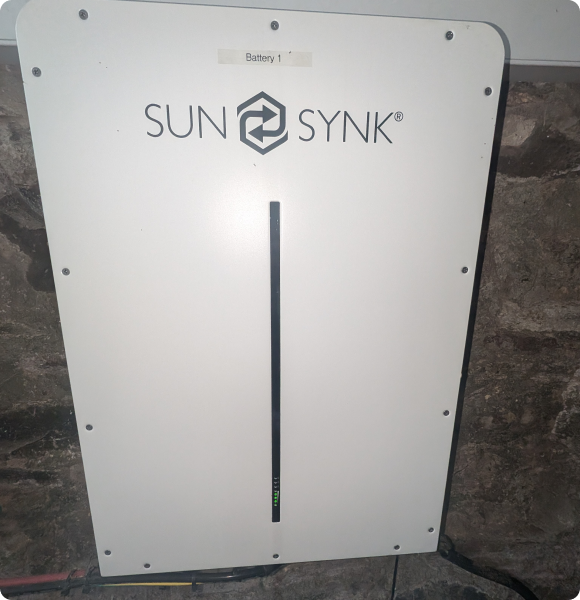 A modular SolaX Triple Power solar battery storage system installed on a garage wall for home energy storage in Scotland.
