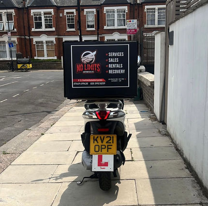 White Liberty Aus Motorcycle. Carrier box on the rear spoiler with No Limits Logo and contact details