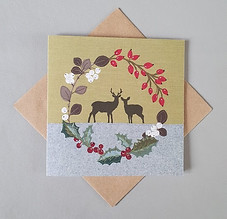 Stag and doe in holly red berry wreath Christmas card