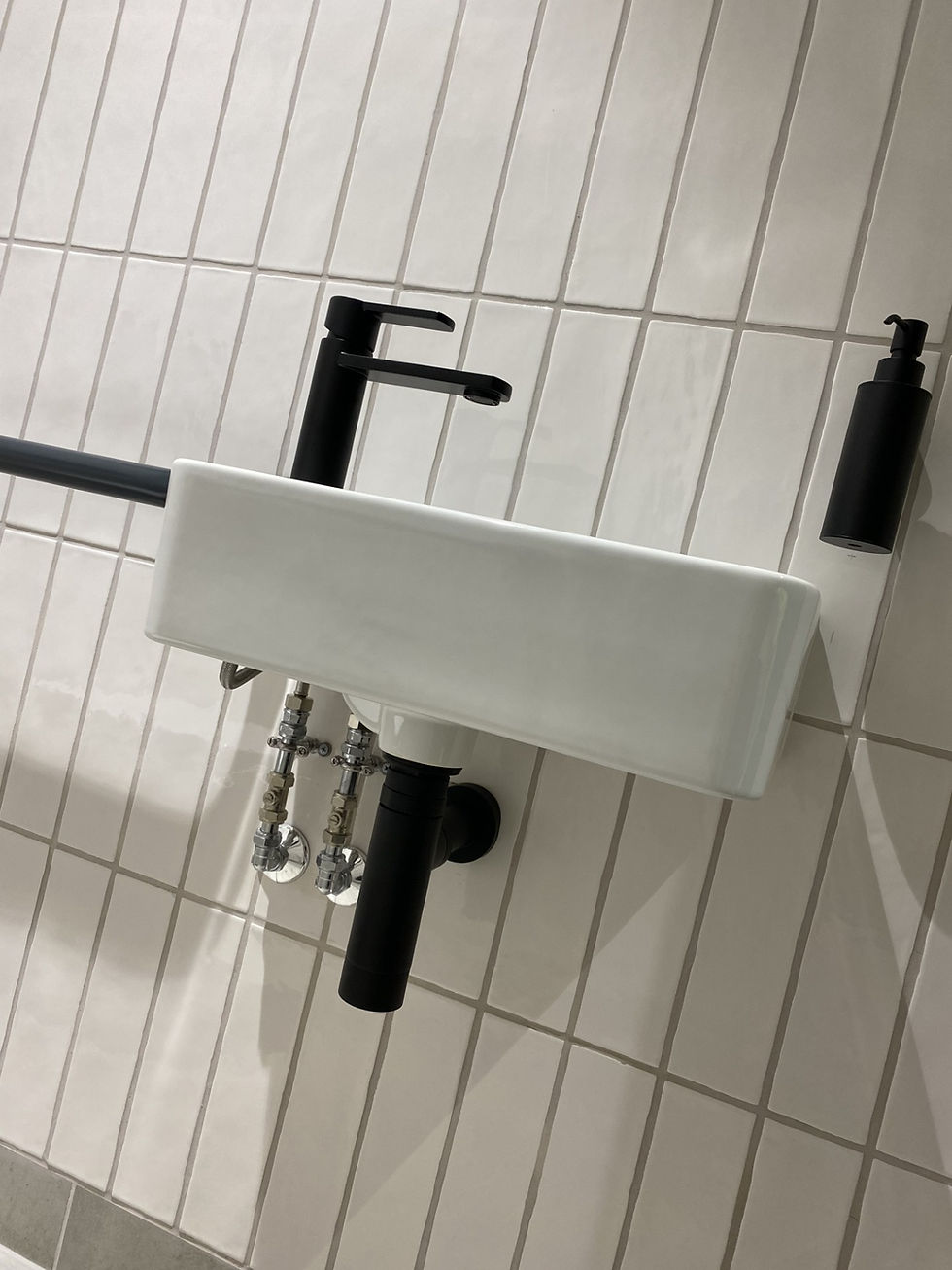 Modern bathroom sink with black faucet and white towel