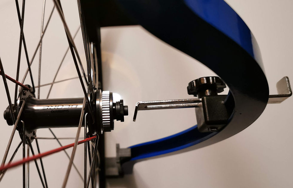 The hub is too far to the left. To correct this, tighten the spokes at the left side. The rim will be drawn in that direction, pushing the hub to the right, reducing the gap to the dishing tool.