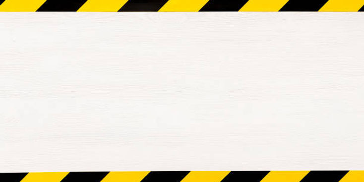 Yellow and black hazard tape frames a blank white space background.