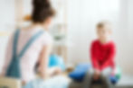 A child speaking with a counselor during child advocacy and family support services