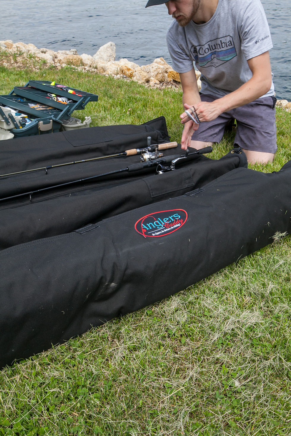 Close-up view of a fishing rod case with multiple compartments