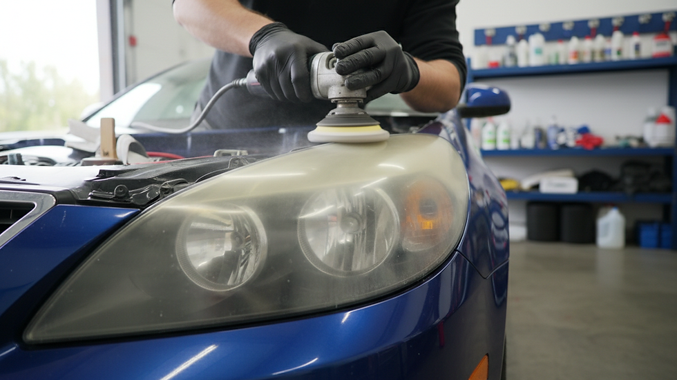Close-up view of a car headlight being polished during restoration