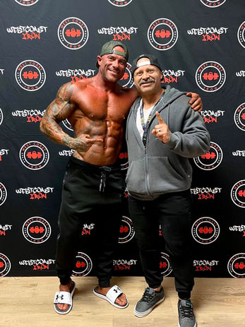 Coach Aaron Jewell takes a picture with another successful transformation and contest prep athlete. Happy clients, happy coach! Start your fitness transformation like this.