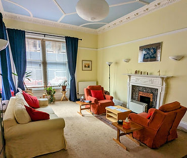 Counselling room with comfortable chairs, soft lighting, and a calm, inviting atmosphere for therapy sessions.