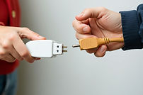 two people holding plugs to fuse them.jpg