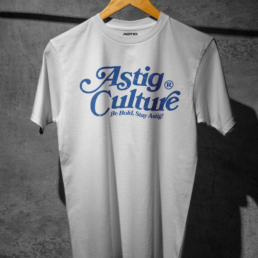 White T-shirt with bold blue text "Astig Culture" in a stylized font. Below, smaller text reads "Be Bold, Stay Astig!"
