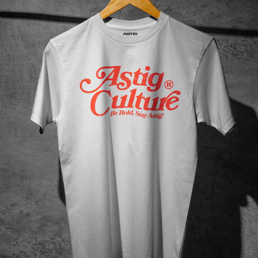 White T-shirt with bold orange text "Astig Culture" in a stylized font. Below, smaller text reads "Be Bold, Stay Astig!"
