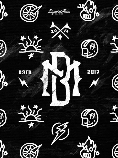 A black-and-white graphic features a central "BM" logo surrounded by skulls, lightning bolts, suns, and wheels. Text reads "BiyakeMoto Klasiko" and "ESTD 2017," evoking a vintage, rebellious vibe.