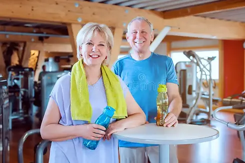 two-seniors-having-break-exercising-gym-looking-camera-165658236.webp