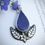 Thumbnail: Nature inspired lapis lazuli necklace. Pear shaped stone with silver leaf border and brass daffodil at the bottom.