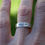 Thumbnail: Amor Fati eco sterling silver ring. Feather on the outside with matte finish and inscription on the inside of the band.