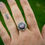 Thumbnail: Ruby Zoisite ring with floral border and three balls at the bottom.