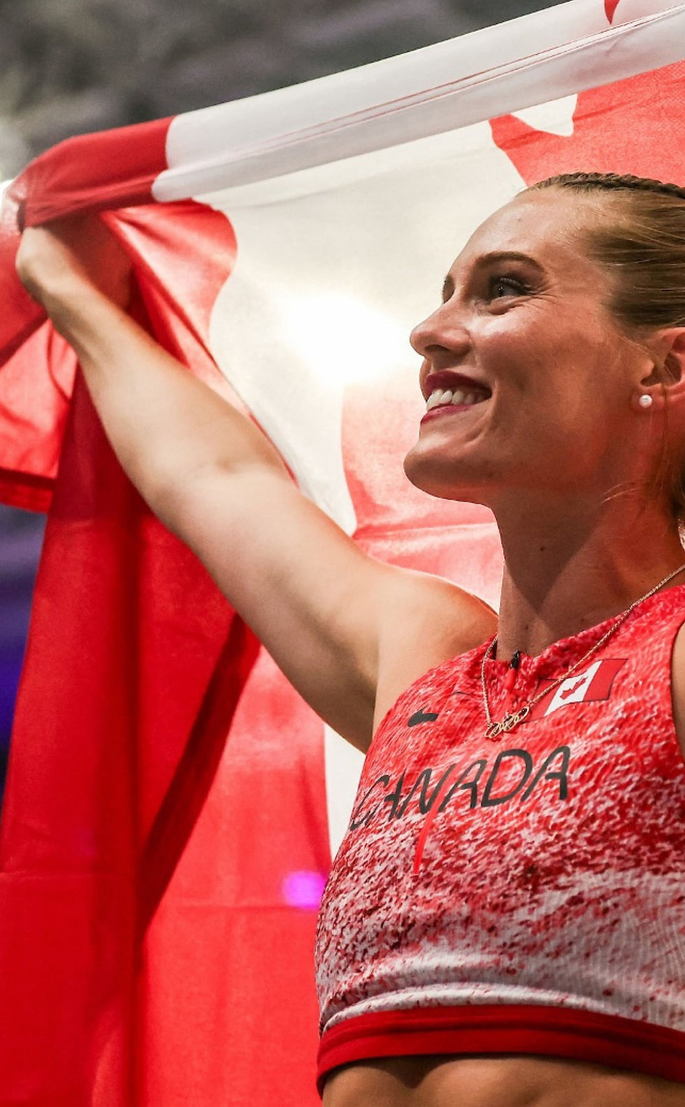 DSP athlete standing with Canada flag at Paris Olympic games
