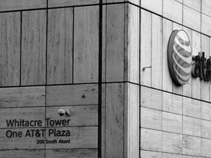 Exterior view of Whitacre Tower, AT&T headquarters at One AT&T Plaza in Dallas, Texas, featuring the AT&T logo and building signage.