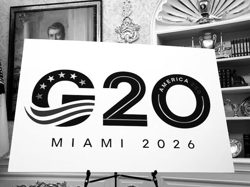 Official logo for the G20 Summit Miami 2026 displayed on a sign at the White House announcement event, featuring bold black text with stars and wave design elements, marking America's 250th anniversary.