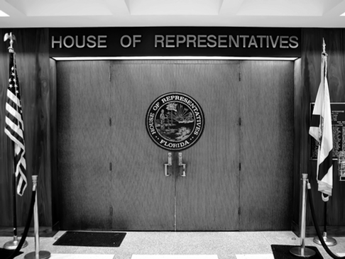 Florida House chamber doors in Tallahassee, where lawmakers are reviewing proposals to eliminate property taxes, expand senior exemptions, and phase out outdated special taxing districts.