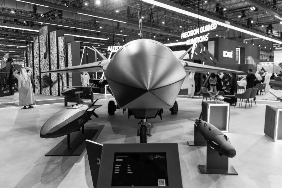 EDGE Group JENIAH stealth unmanned combat aerial vehicle, pictured in black-and-white, displayed with precision guided munitions at Dubai Airshow