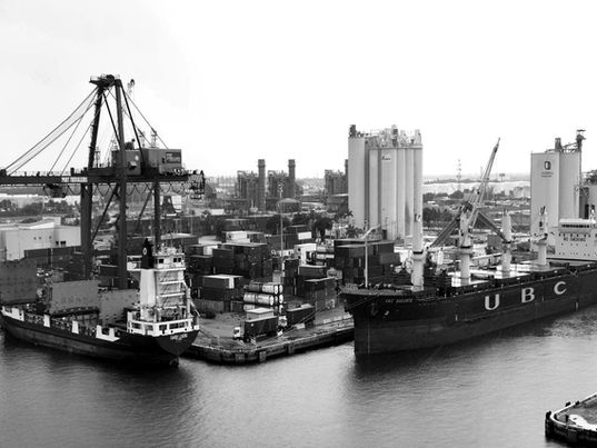 Black-and-white view of Port Everglades in Fort Lauderdale (FLL), Florida, highlighting cargo vessels, container operations, port cranes, and the maritime infrastructure driving international trade, logistics, and economic development