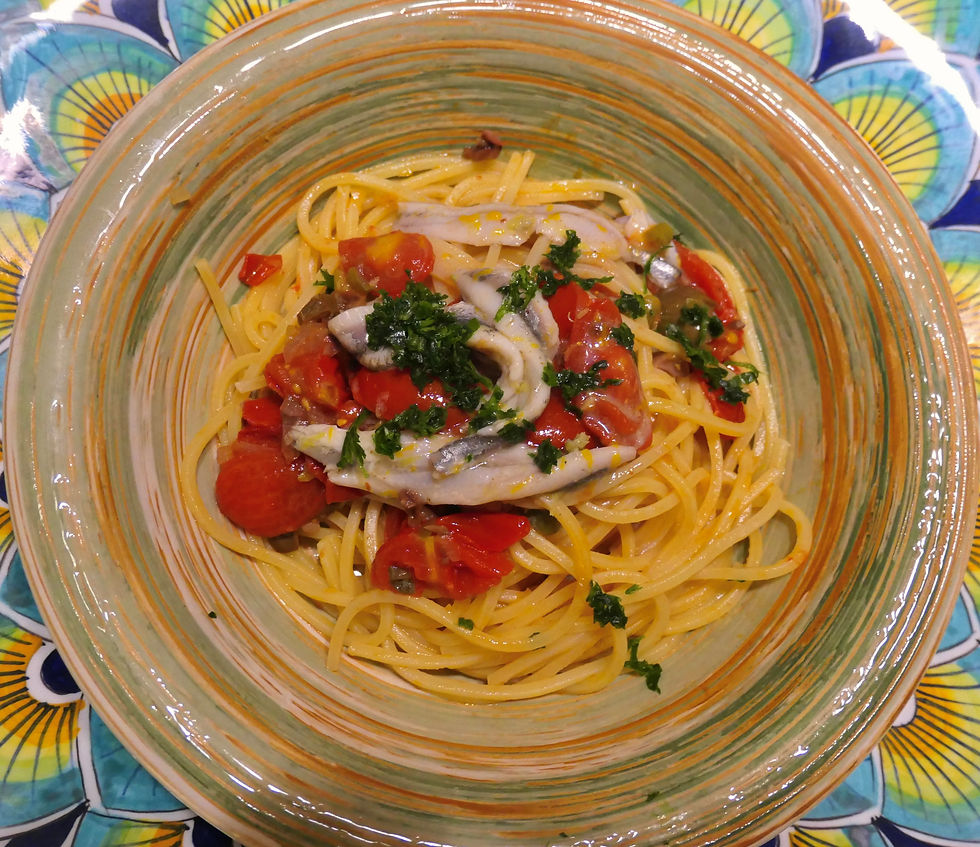 a bowl of spaghetti with fresh anchovies