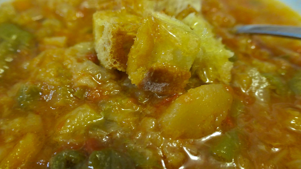 a close-up of minestrone soup with croutons