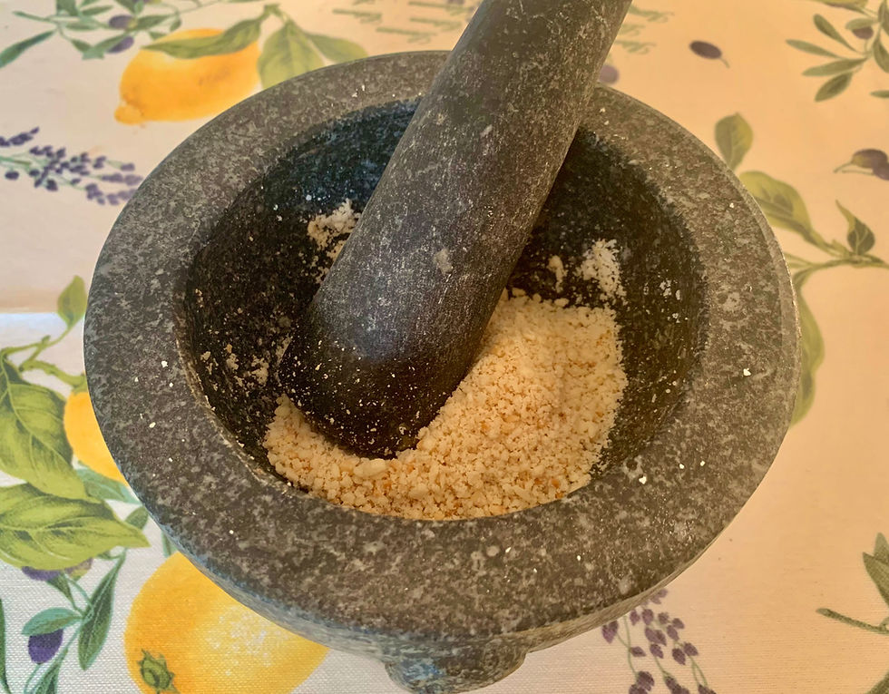 grinding almonds in a mortar & pestle