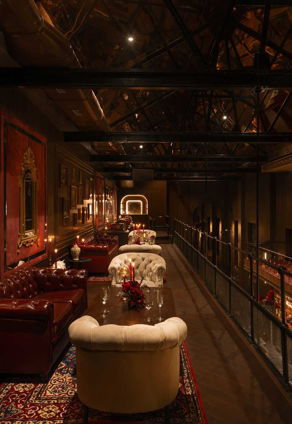Invite-only mezzanine seating at FIELIA Mumbai with leather sofas, candlelit tables and theatre-style balcony overlooking the cocktail bar