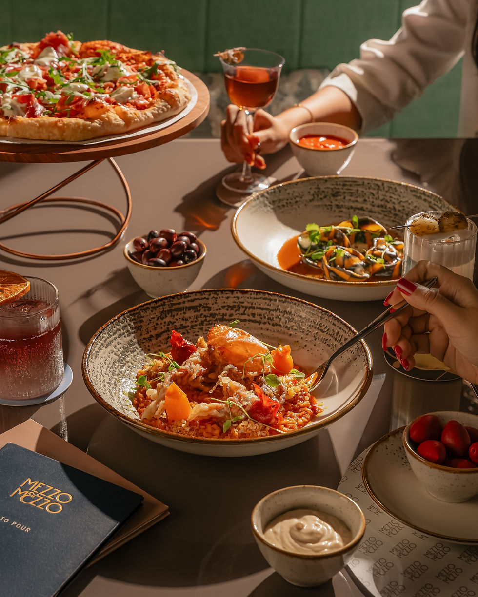 The food offering at Mezzo Mezzo - JW Marriott Mumbai Juhu's Newest Restaurant. Pizza, seafood risotto, and drinks.