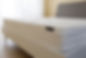 White orthopedic mattress top side surface pattern on unmade bed in the bedroom. Hypoaller