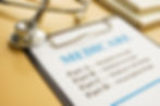 Clipboard laying on a desk. A sheet of paper is ontop of the clipboard,
Medicare 101'