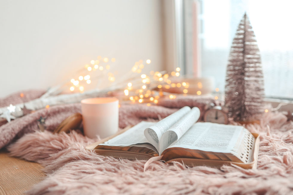 Cozy winter scene with a mug, an open book, and fairy lights