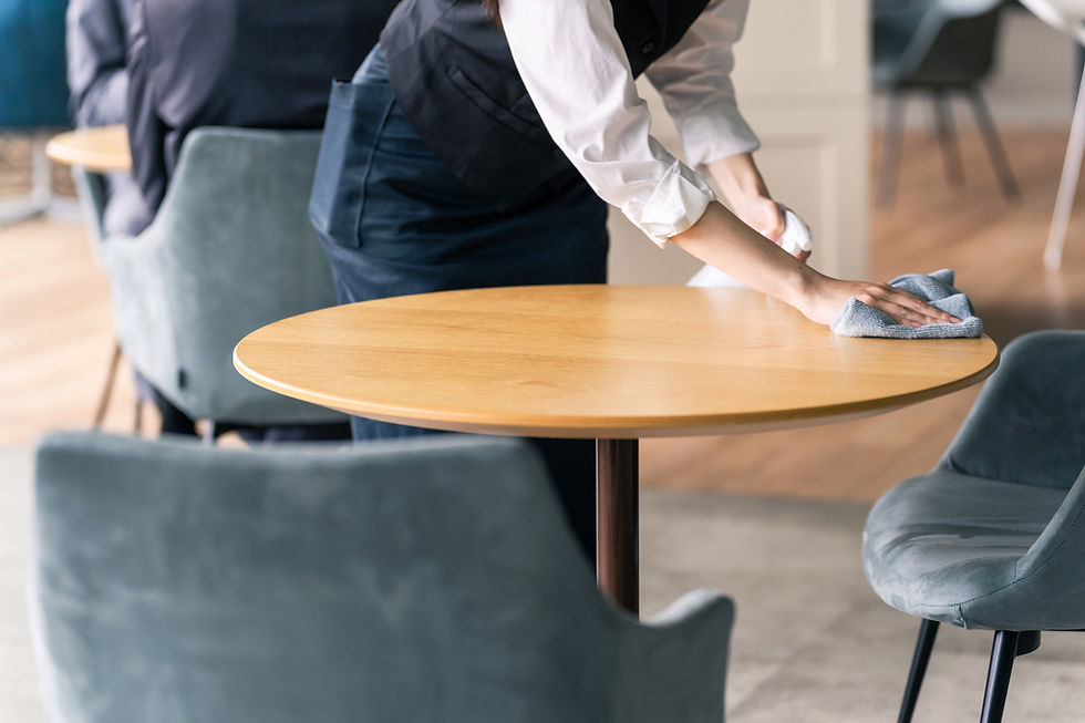Hall staff cleaning a table. Restaurant clerk..jpg