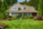 house-with-front-yard-with-green-grass-and-landscaping--scaled.jpg