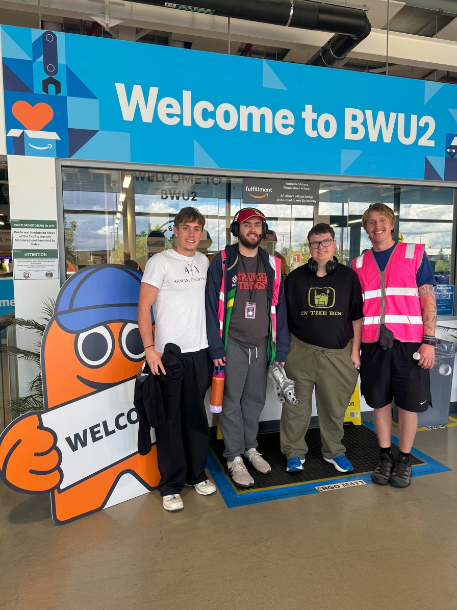 Photography of four individuals and an orange mascot standing at the entrance of a building. A prominent sign reads "Welcome to BWU2", creating a welcoming atmosphere.